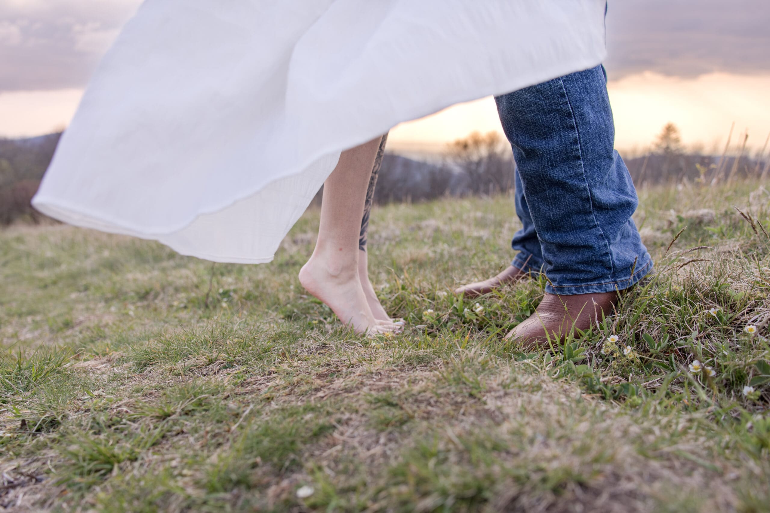 Close up of couple standing on top of a mountain at sunset in the Cherokee Mountains